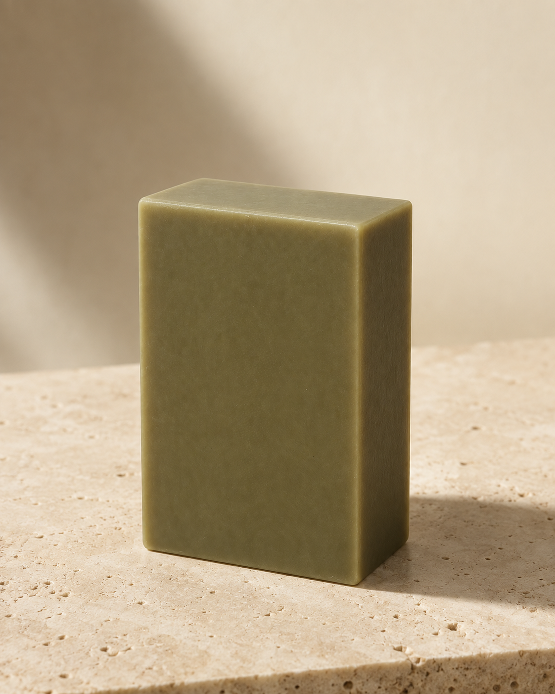 Bamboo Mud — dry bar standing on a travertine ledge in natural light